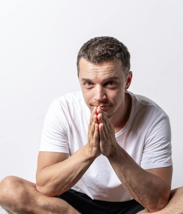 Person meditating peacefully with a calm expression.